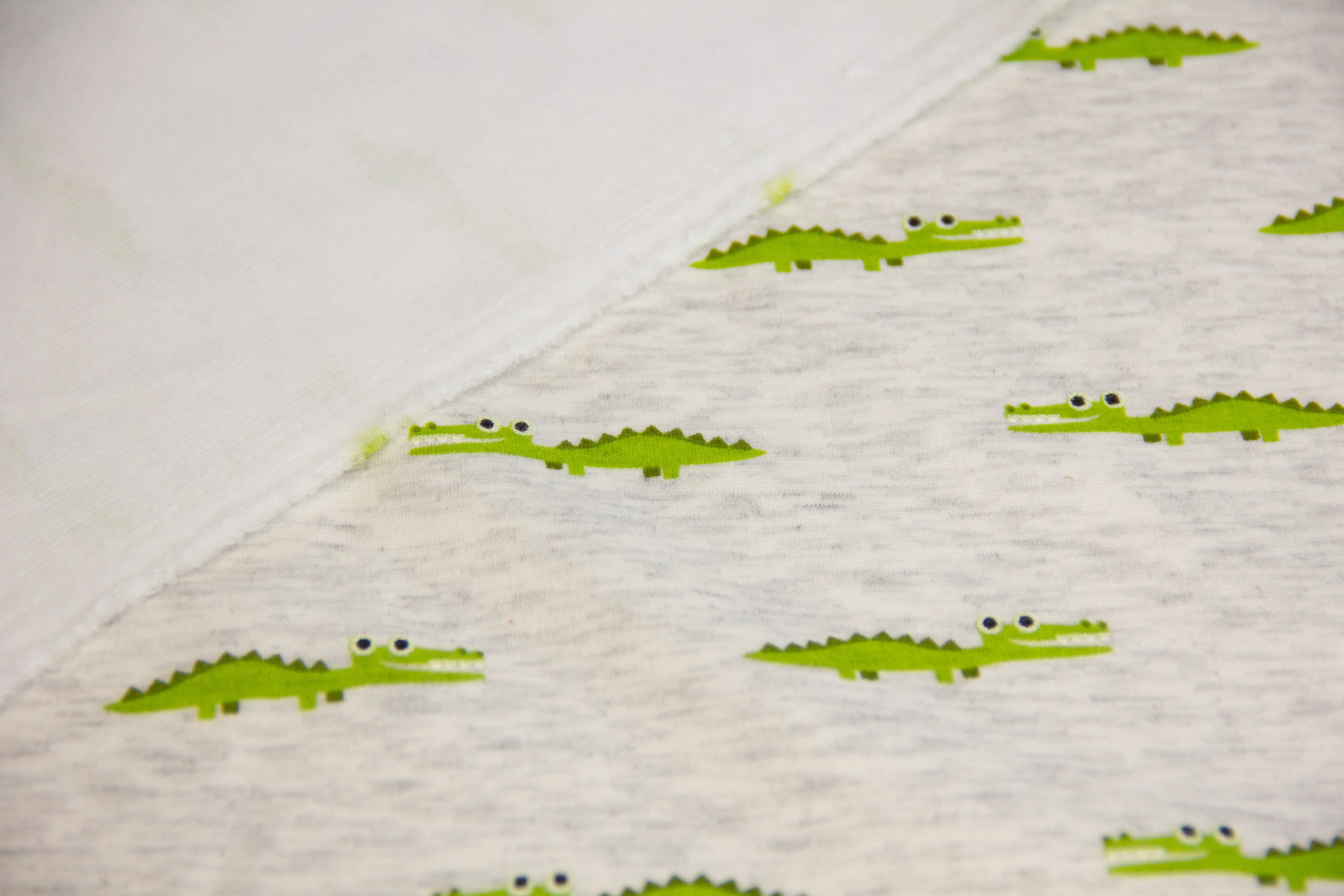 Alpenfleece mit Krokodilen, natur meliert, 0,5 m