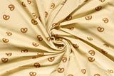 Jersey mit Brezen beige Meterware online kaufen