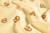 Jersey mit Brezen beige Meterware online kaufen Babybody